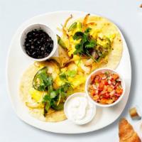 Huevos Rancheros · Lightly fried eggs served on a warm tortilla and topped with salsa, tomatoes, chili peppers,...