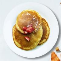 Let Them Eat Pancakes · Three fluffy house pancakes cooked with care and love.