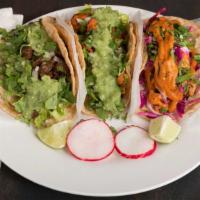 Tacos · Served in a corn tortilla with onions, cilantro, lettuce and mild salsa verde.