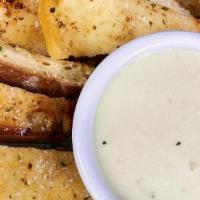 Garlic Bread Appetizer · Fresh baked semolina stick bread with a garlic butter spread and a creamy three cheese dippi...