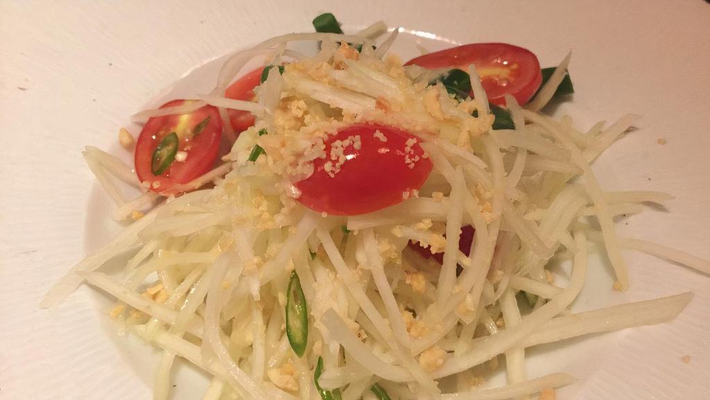 Green Papaya Salad · Spicy. Tomato, peanuts, string beans and fresh lime juice. Mildly spicy.