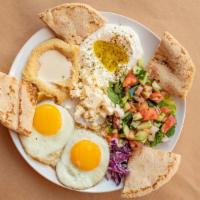 Middle Eastern Breakfast · Favorite. Two eggs any style, hummus, labneh, cabbage salad, feta, Israeli salad and a whole...