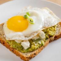 Greek Avocado Toast · Sunny side up egg on avocado toast with feta.
