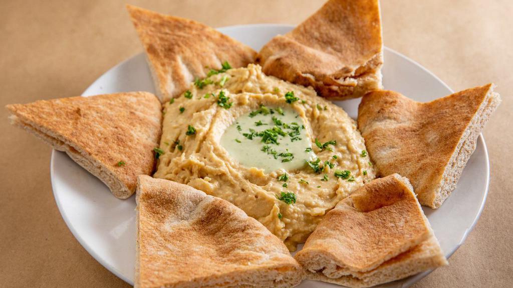 Hummus · Served with whole wheat pita.