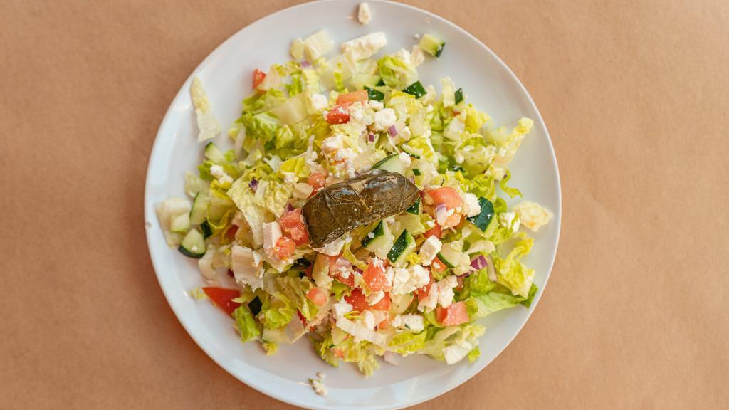 Greek Salad · Romaine lettuce, tomato, cucumber, red onion, feta and grape leaves with virgin olive oil and lemon juice.