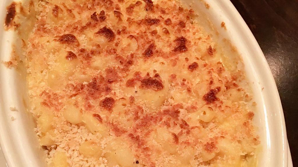 Mac & Cheese · Cavatappi pasta baked in a three cheese bechamel sauce and topped with golden bread crumbs.