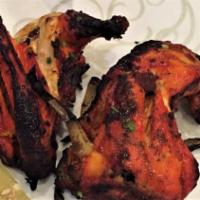 Chicken Tandoori · Chicken marinated in mild spices and grilled in clay oven.