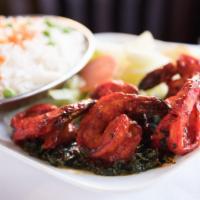 Shrimp Tandoori · King-sized shrimp marinated, grilled in clay oven and served with mushroom or spinach.