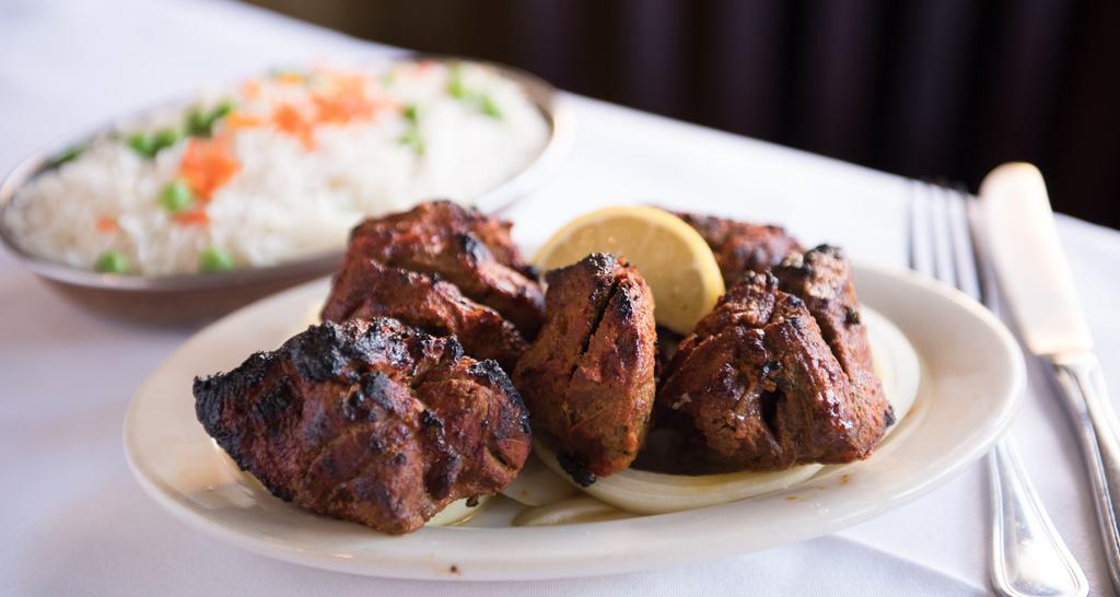 Boti Kebab · Cubed leg of lamb marinated in milk spices and grilled in clay oven.