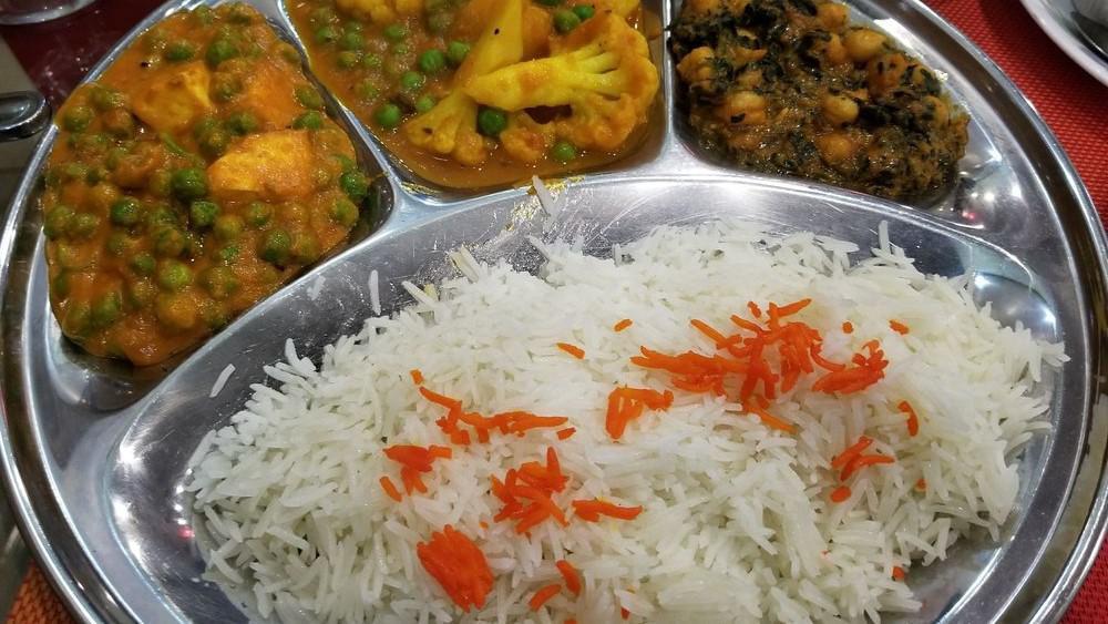 Vegetarian Thali · Motor paneer, chana saag and mixed vegetable curry. Served with basmati rice and naan.