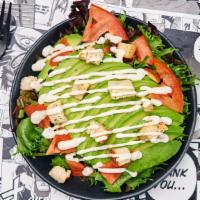 Roasted Sesame Avocado Salad · Spring mix salad with crunchy garlic croutons, avocado, tomatoes and candied almonds dressed...