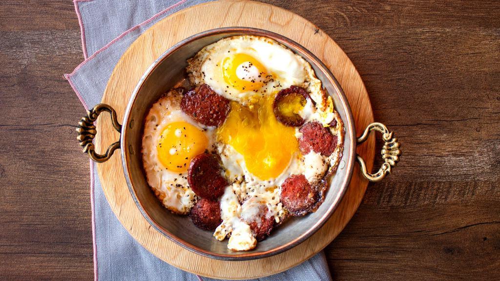 Turkish Sunny Side Eggs With Soujouk · Three farm eggs with Turkish beef soujouk.