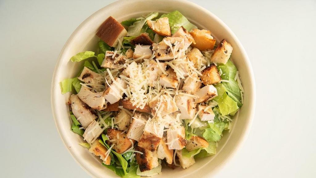 Grilled Chicken Caesar Salad · Romaine Hearts, Parmesan & Croutons
