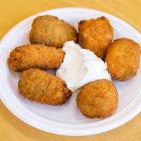 Jalapeño Poppers (6) · Jalapeños stuffed with cheddar cheese, served with sour cream.