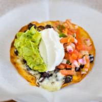 Tortilla Pizza · Crispy flour tortilla topped with melted jack and cheddar cheese, sour cream, guacamole, fre...
