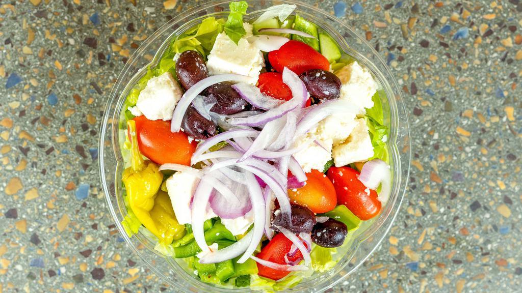 Greek Salad · Chopped romaine lettuce, feta, tomatoes, cucumbers, bell peppers, red onions, kalamata olives, grape leaves and our house vinaigrette. Served with pita bread.