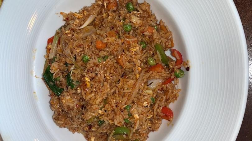 Spicy Fried Rice · Chili paste, egg, onions, scallions, peppers, peas, carrots, and basil.