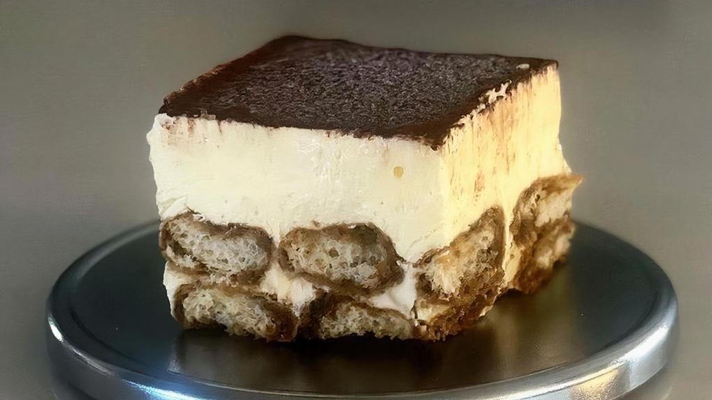 Tiramisu · Imported ladyfingers hand-dipped in a custom espresso mixture, layered with mascarpone imported from Italy, then finished with a generous dusting of premium cocoa powder..