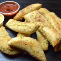 Garlic Parm Stix · 10 D.P. Dough stix covered with our Garlic Parmesan seasoning. Comes with sides of marinara ...
