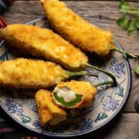 Jalapeño Poppers · 6 pieces of jalapeño poppers filled with cheddar cheese, battered and fried to perfection. S...