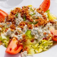 Loaded Wedge Salad (Gf) · Iceberg lettuce with tomatoes, smoked bacon, chives, and crumbled bleu cheese with bleu chee...