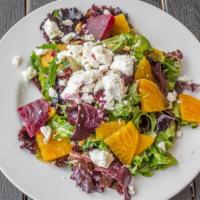 Beet Salad · Sliced beets with mixed baby greens, walnuts, goat cheese, and raspberry vinaigrette dressing.