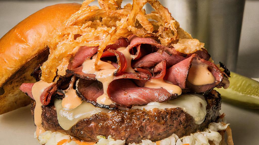 Pastrami Burger · Swiss cheese, crispy onions, celery root cole slaw, Russian dressing and smoked pastrami. Fries on the side.