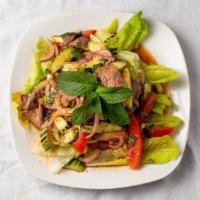 Beef Salad · Sliced grilled sirloin strips with mint leaves, lemongrass, onion & hot pepper in lime juice.