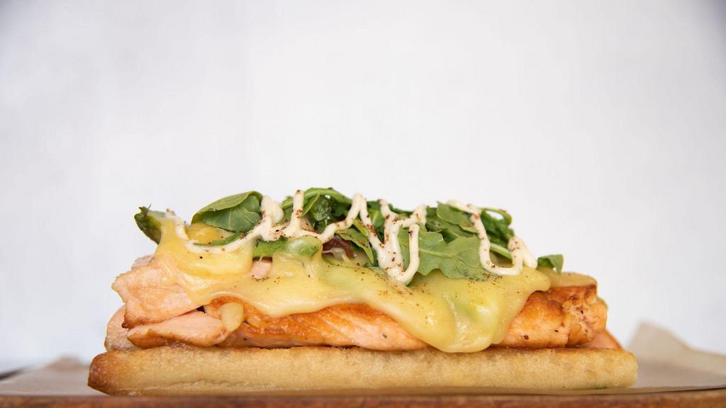 ..Salmon And Avocado Raclette Sandwich · Grilled salmon filet, sumac mayo, Pico de Gallo, avocado, fresh lime juice, baby arugula, and raclette cheese. Served on a home-baked baguette.