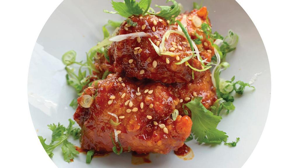 Sriracha Honey Chicken · Japanese fried chicken with homemade sriracha honey spicy sauce, scallion, cilantro and sesame