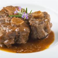 Oxtail · Delicious juicy tail of the ox made with housemade spices, served with 2 sides.