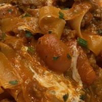 Pappardelle Bolognese · Fresh made pasta in a rustic tomato-meat sauce.