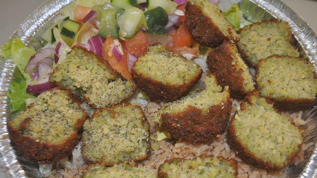 Falafel Rice Platter · Seasoned basmati rice with fresh ground chick peas with vegetables and added Mediterranean spices with sauce with lettuce, onions, tomatoes and cucumbers.
