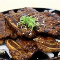 La Galbi Platter (갈비프레터) · Korean Rib with Special Galbi Sauce over Fried Onion.  Rice, Spicy Soy radish and Kimchi. Pe...