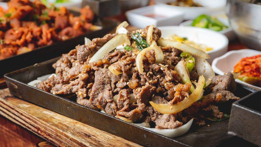 Bulgogi Platter (불고기 프래러) · Korean Bulgogi over Fried Onion.  Rice, Spicy Soy radish and Kimchi. Perfect Dinner Portion for you!