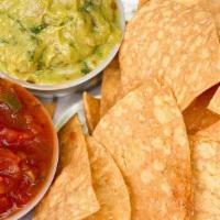 Curbside Guacamole & Chips · Freshly made guacamole seasoned with fresh onions, cilantro, tomatoes and a hint of lime jui...
