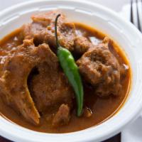Goat Curry · Gluten-free. Hearty goat in a traditional savory curry served with a side of basmati rice.