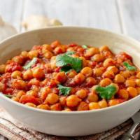 Chana Masala · Vegan and gluten-free. Chickpeas simmered in a tomato stew served with a side of basmati rice.