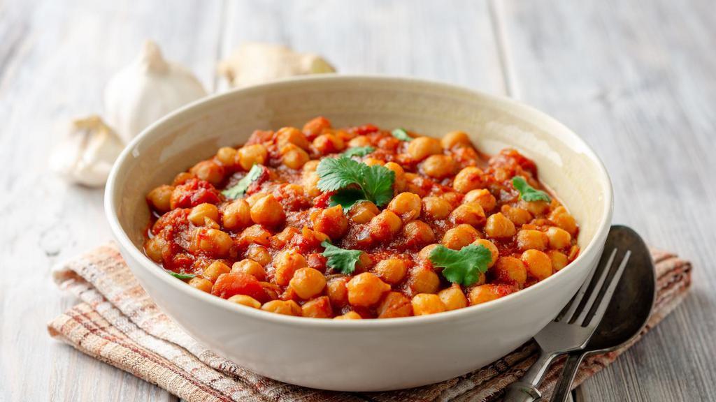 Chana Masala · Vegan and gluten-free. Chickpeas simmered in a tomato stew served with a side of basmati rice.