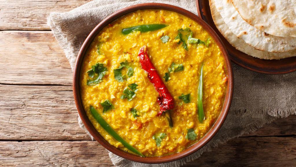 Yellow Dal · Gluten-free. Tender lentils stewed in a savory curry and served with a side of basmati rice.