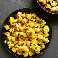 Aloo Gobhi · Vegan and gluten-free. Tender cauliflower and potatoes sautéed with tomatoes and onions and ...