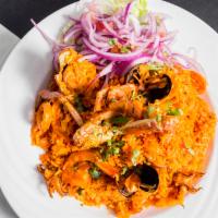 Arroz Con Mariscos Y Camarones · Peruvian style paella with seafood or shrimp served with yellow rice and mixed vegetables.
