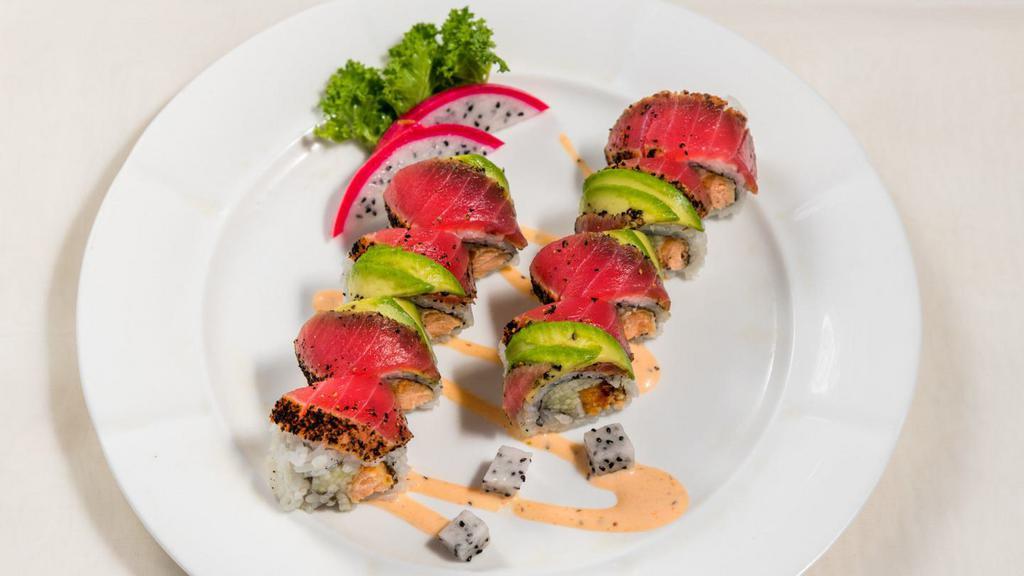 Teriyaki Roll · Cooked salmon and cucumber. Topped with peppered tuna, avocado, and eel sauce.