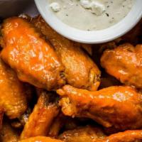 Buffalo Wings · Crispy buffalo wings topped with regular or extra spicy buffalo sauce and served with carrot...