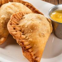 Empanadas · 1110 -1170 cal. Handmade pastries filled with mixed cheese and chicken tinga or seasoned gro...