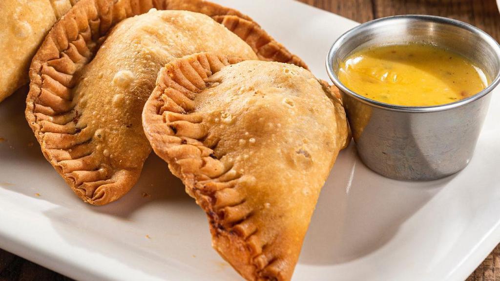 Empanadas  · Two handmade pastries filled with mixed cheese & chicken tinga or seasoned ground beef. Served with our signature queso.