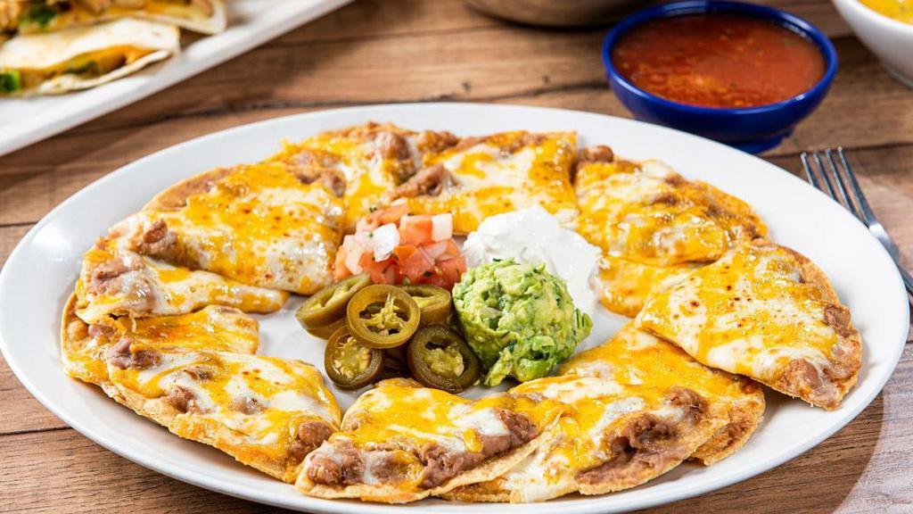 Grande Bean & Cheese Nachos · Tostada chips topped with refried beans and melted mixed cheese. Served with guacamole, sour cream, pico de gallo and pickled jalapeños.