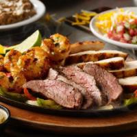 Grande Fajita Trio · The ultimate combo of mesquite-grilled steak, chicken and shrimp, with sautéed vegetables. S...