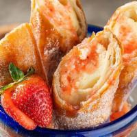 Strawberry Cheesecake Chimis · Golden fried cheesecake-filled chimichangas and strawberry puree.