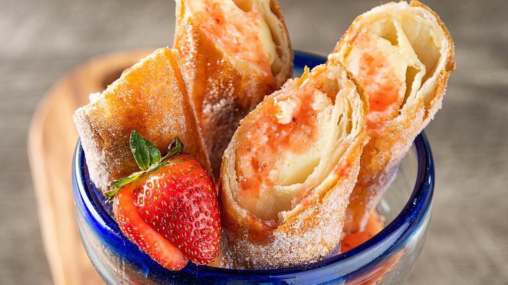 Strawberry Cheesecake Chimis · Golden fried cheesecake-filled chimichangas and strawberry puree.
